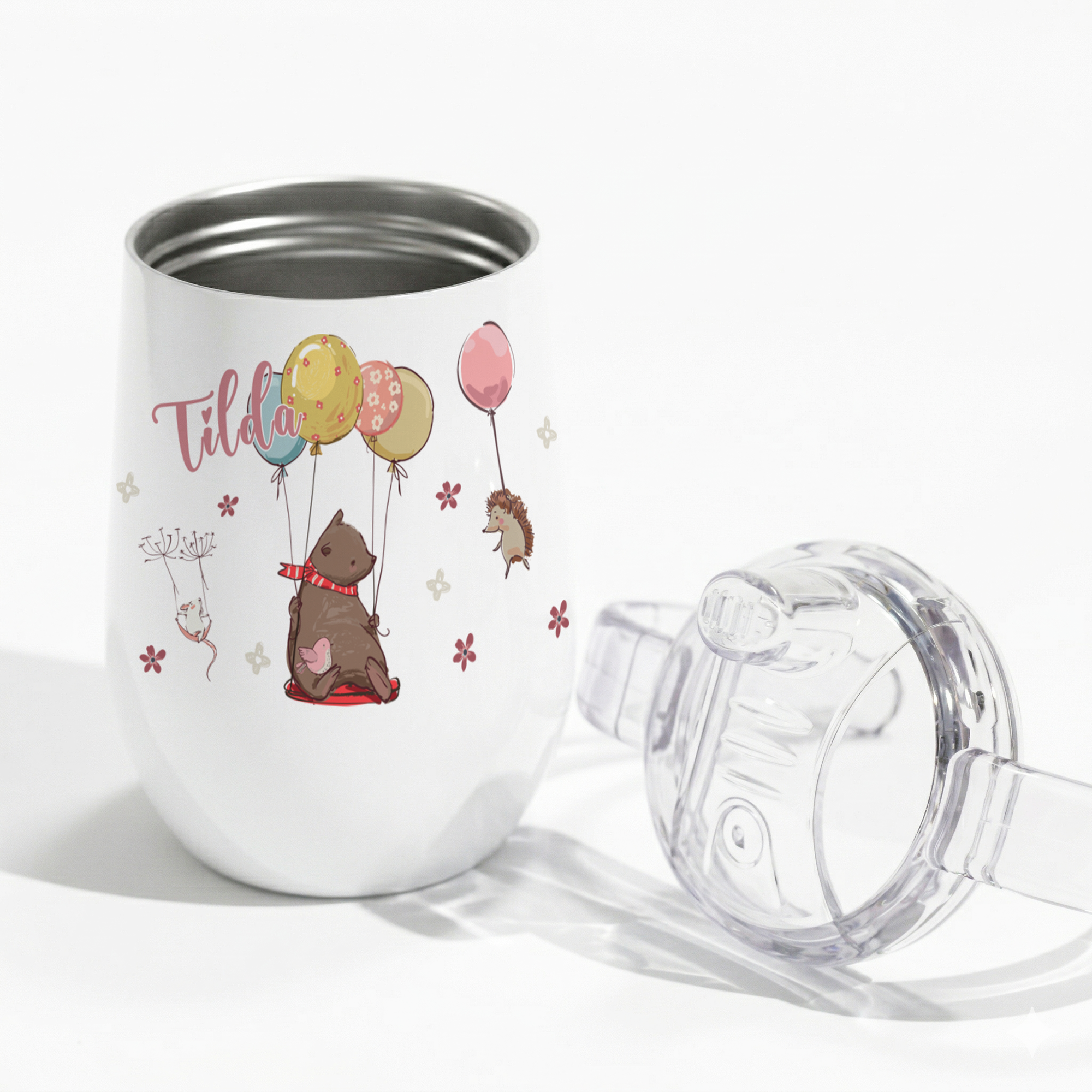 Weißer Edelstahlbecher mit bunten Ballons und Tiermotiven.