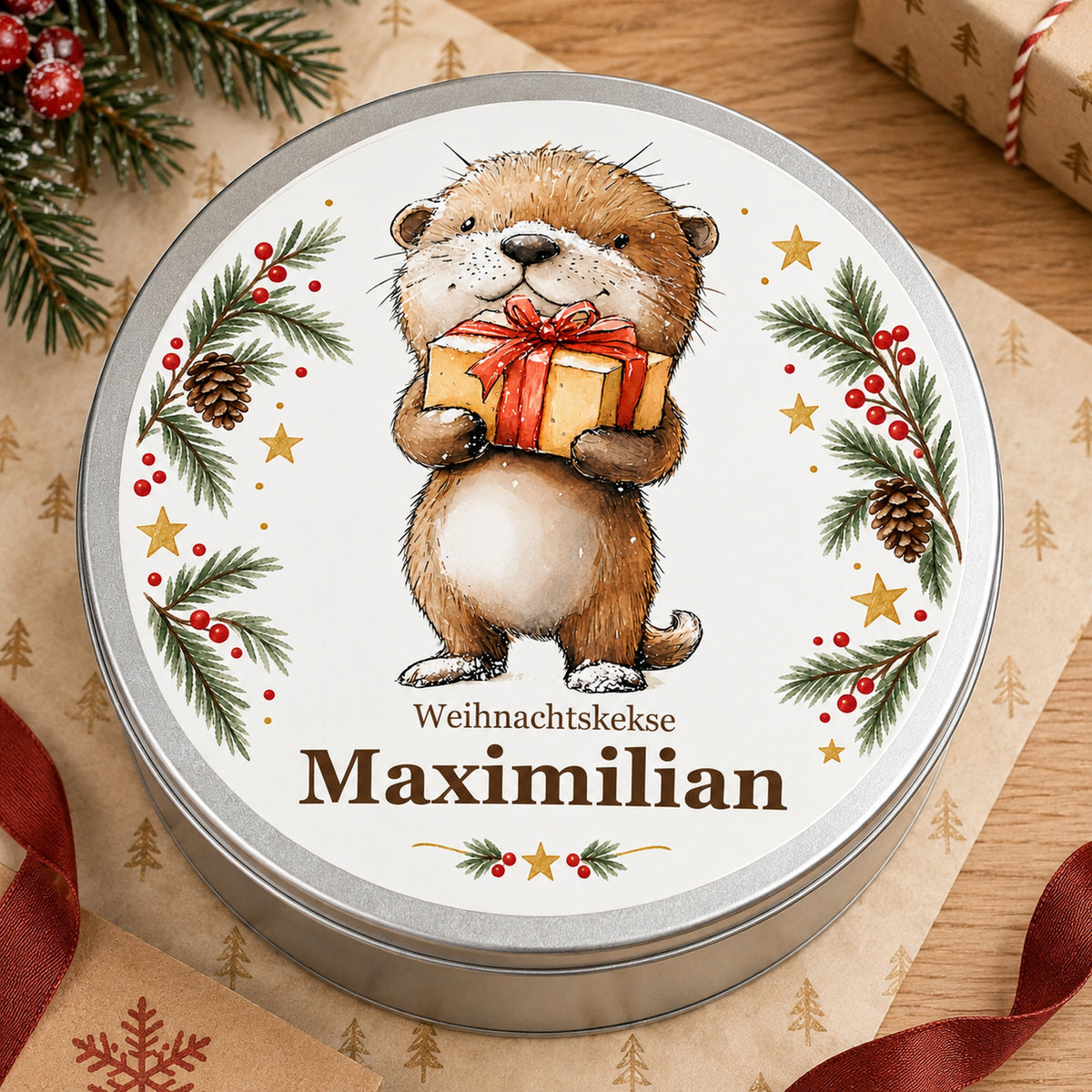 Keksdose Weihnachten, Otter mit Geschenk, mit Wunschname von oben neben Geschenkpapier und rotem Band