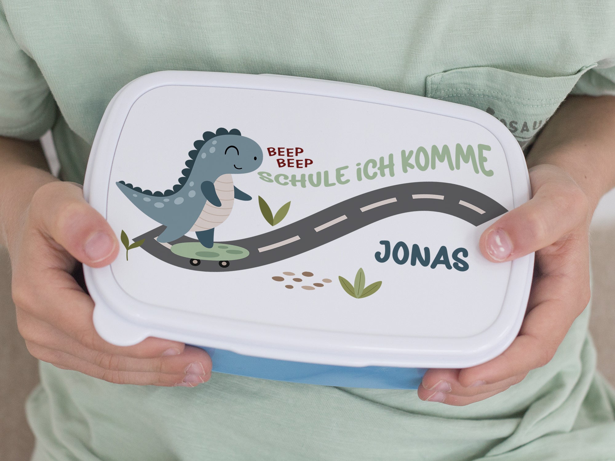 Lunchbox mit Dinosaurier-Motiv und personalisiertem Namen Jonas.