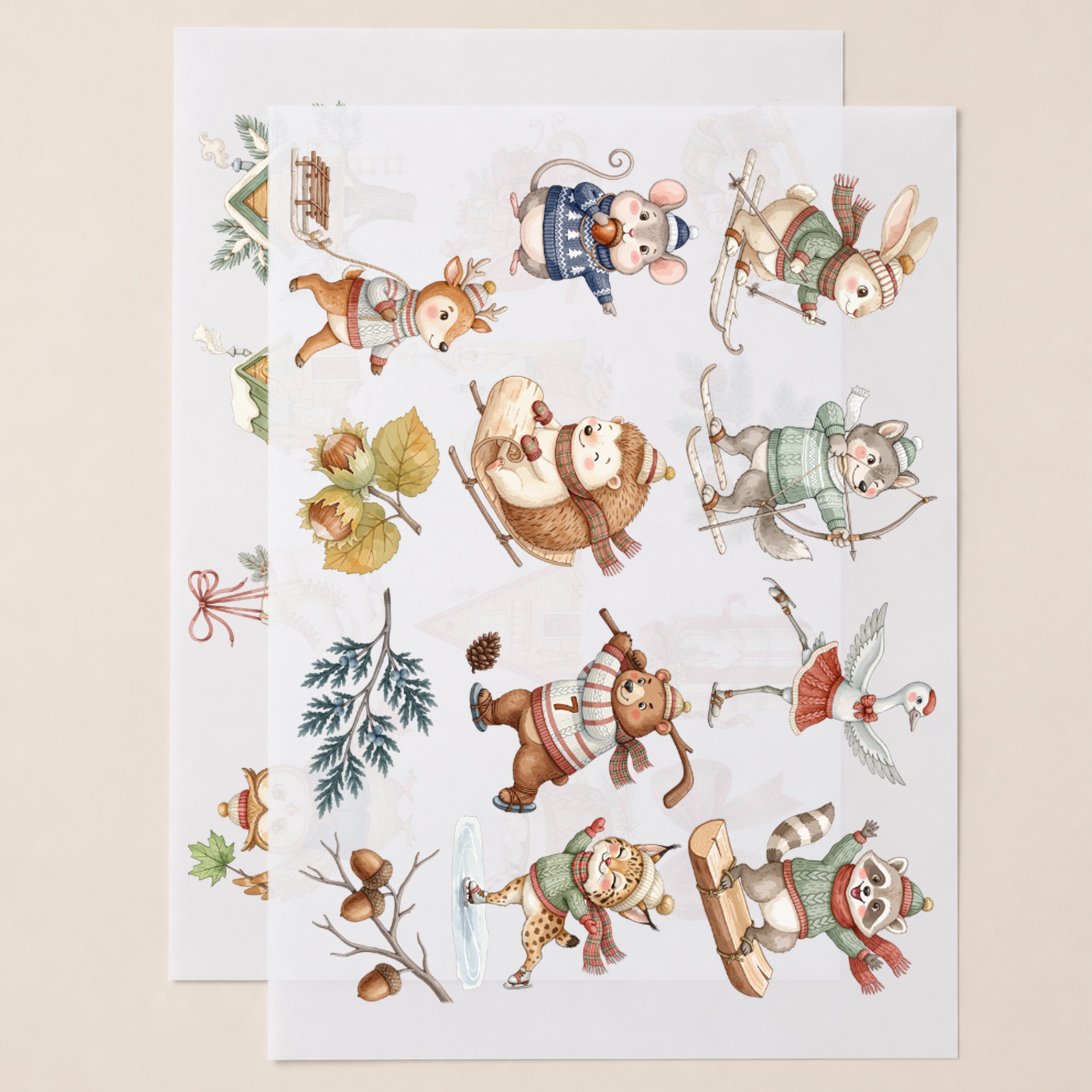 Zwei DIN-A4-Bögen mit winterlichen Tier-Bügelbildern und Motiven wie Schlitten, Häuser und Geschenke