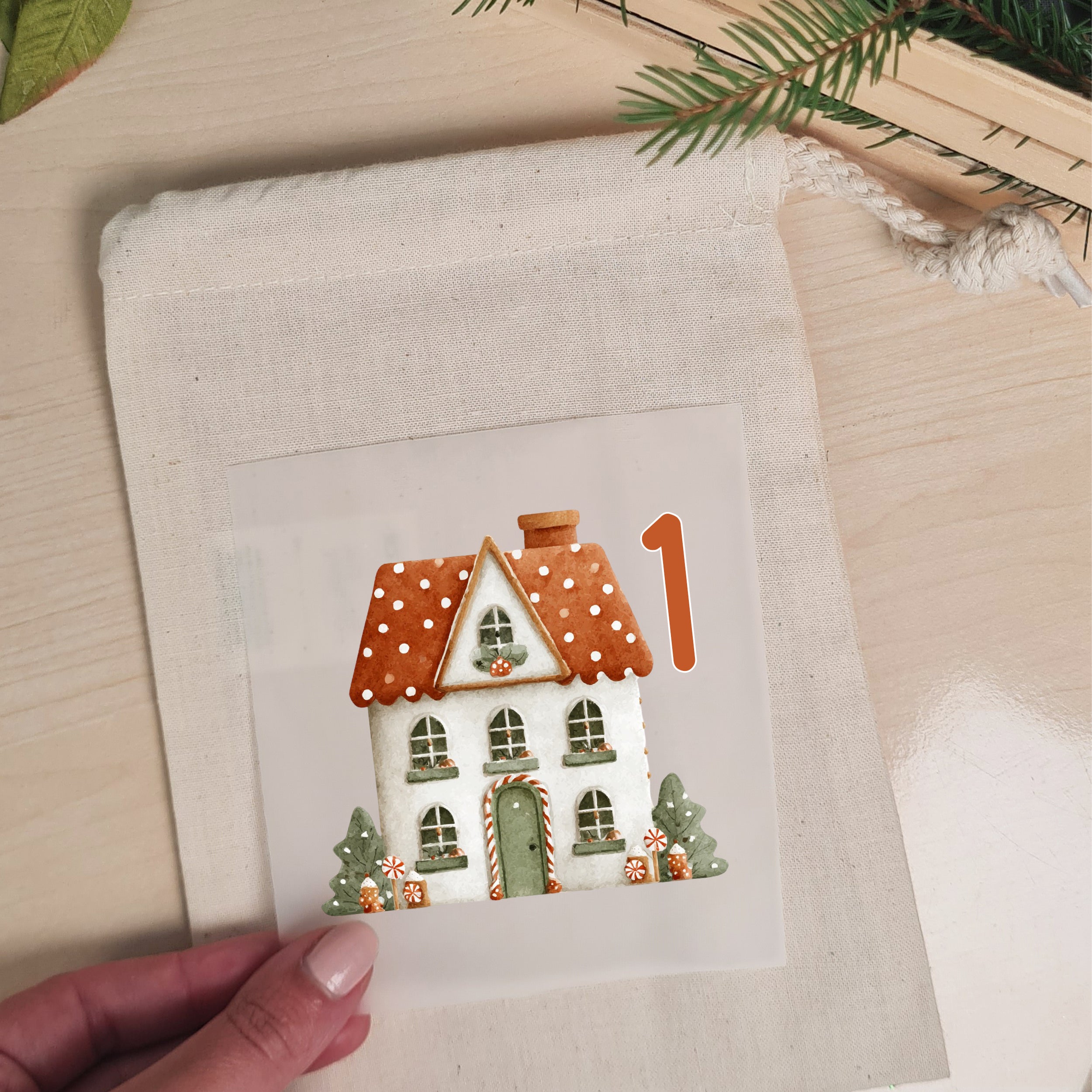 Winterhaus mit Zahl 1 als Bügelbild auf einem naturfarbenen Stoffbeutel