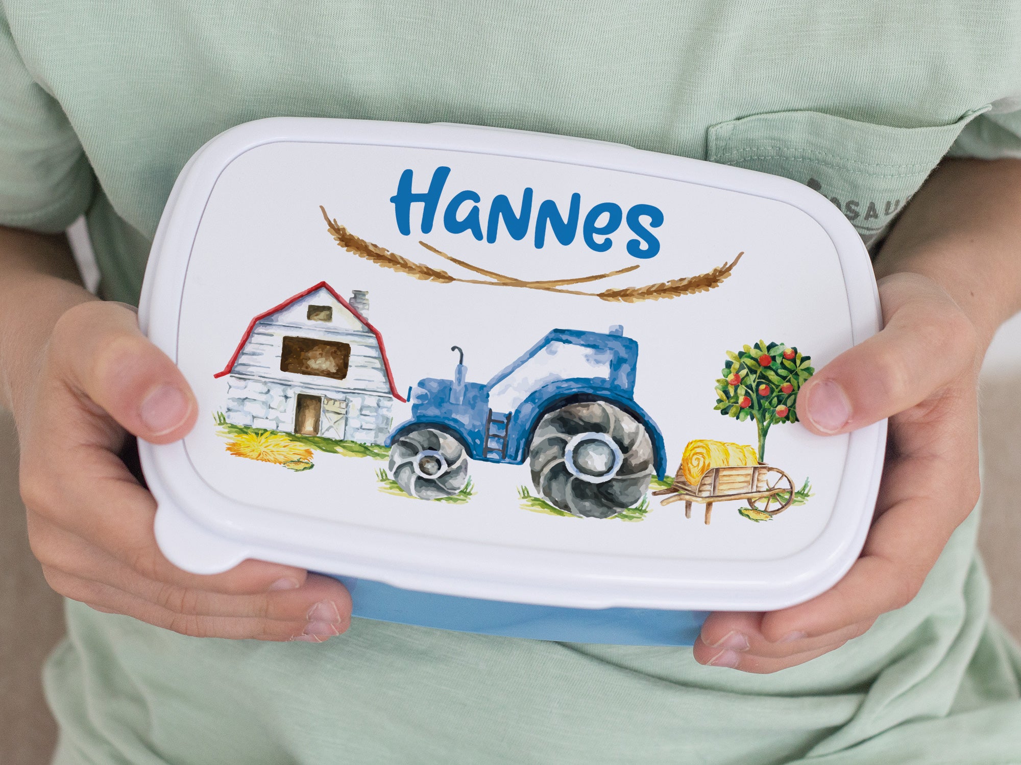 Bunte Brotdose mit Traktor-Design und Namen Hannes.