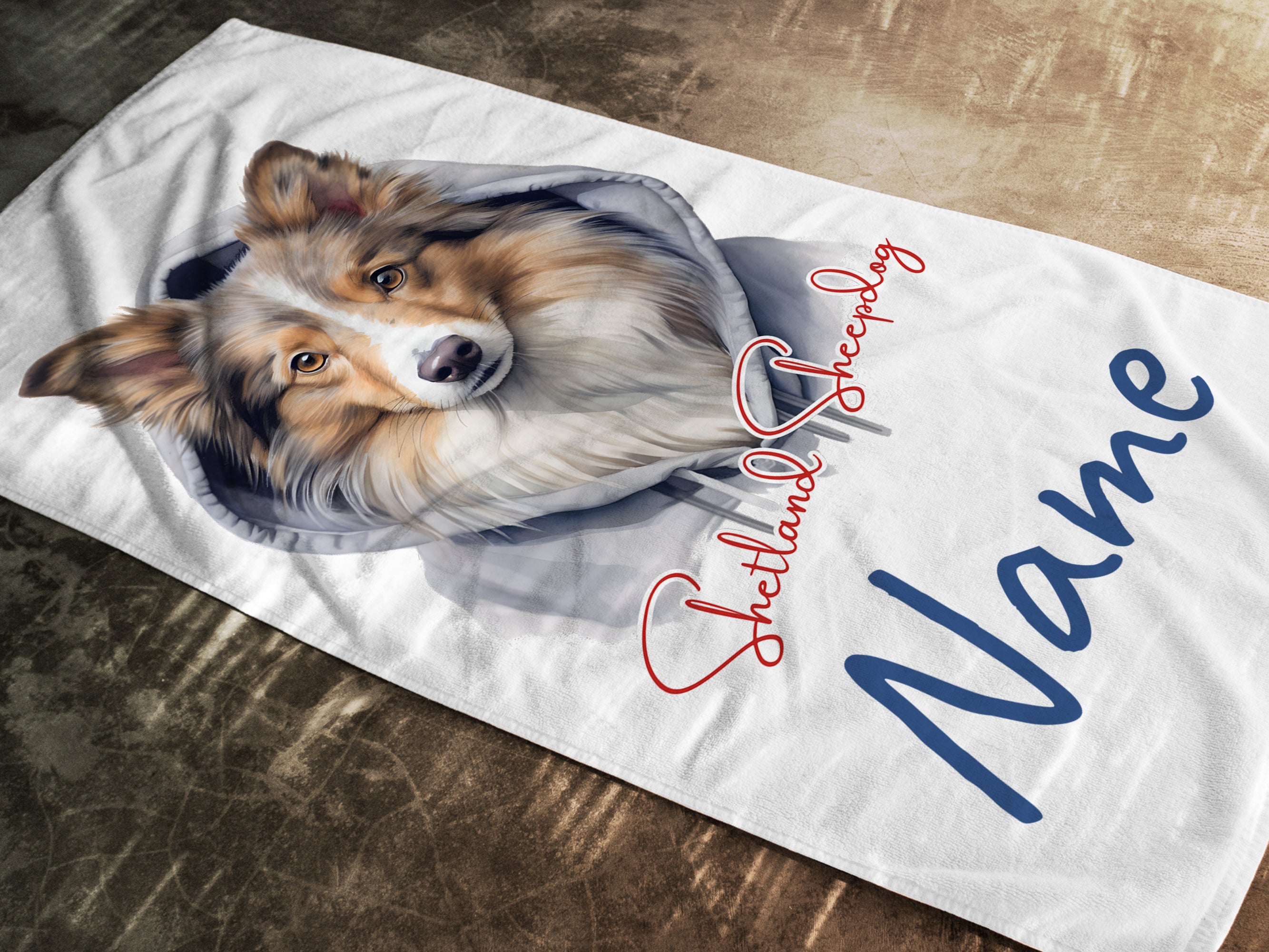Weißes Handtuch mit Collie-Motiv und personalisiertem Namen.