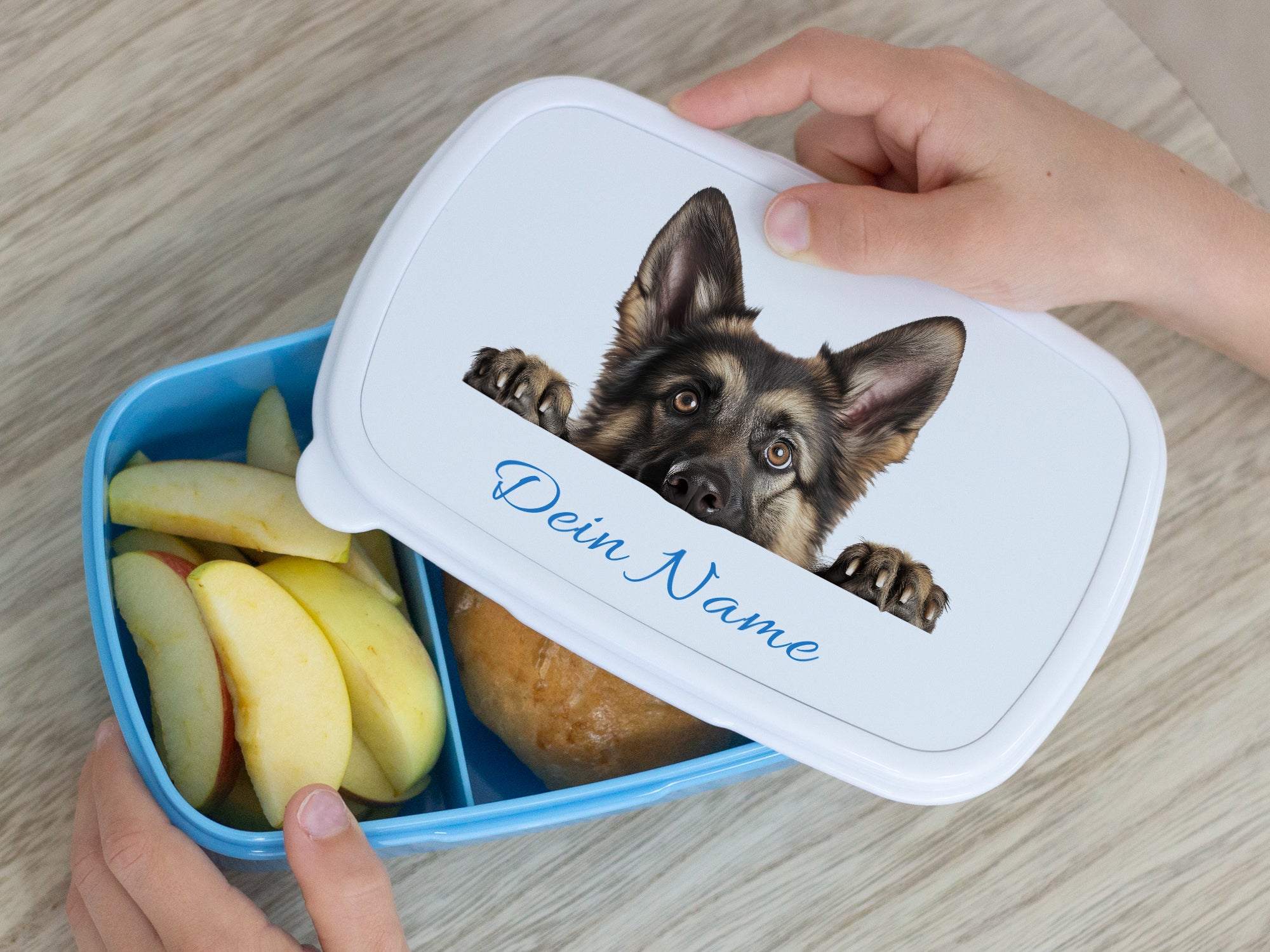 Blaue Lunchbox mit Hundemotiv und personalisiertem Namen.