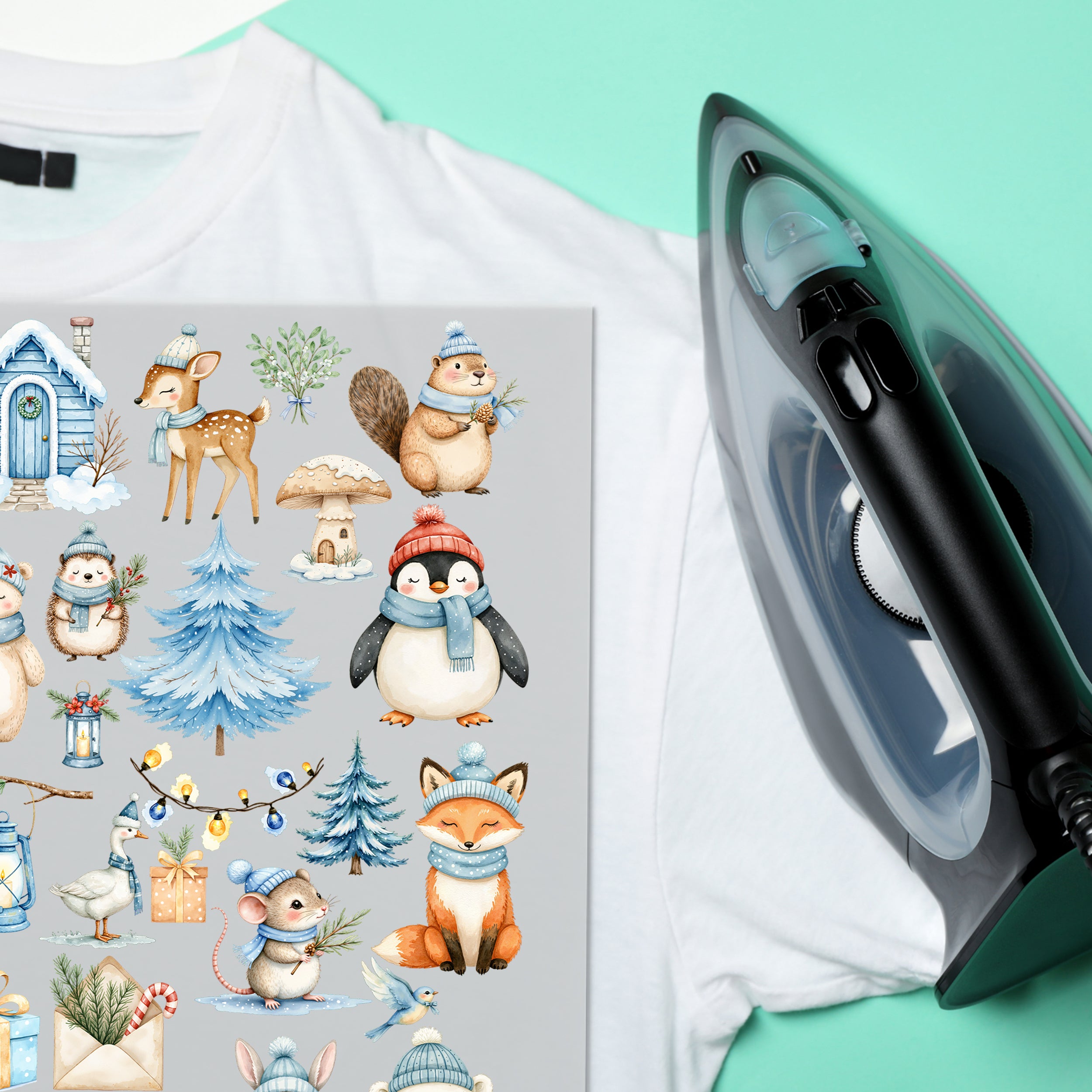 Wintertier-Bügelbilder auf weißem T-Shirt neben einem Bügeleisen