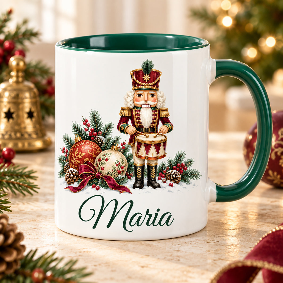 Weiße Keramiktasse mit grünem Henkel und grüner Innenseite, Motiv Festlicher Trommler und Wunschname vor weihnachtlicher Dekoration.
